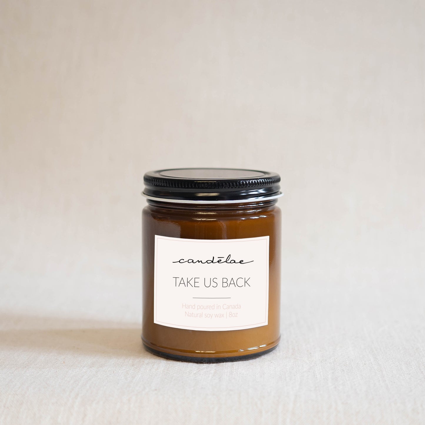 Take us back a scented candle by candēlae containing Bergamot and Frankincense is ready for photo